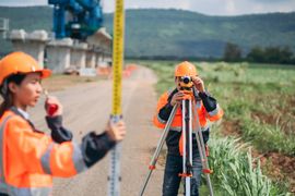 survey-team-is-working-with-a-theodolite-and-road-2025-03-26-21-28-19-utc -1-